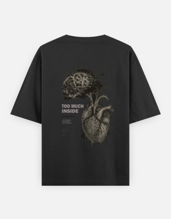 Oversized streetwear T-shirt featuring Too Much Inside Emotional Graphic Tee India typography on the front and artistic heart graphic print on the back, photographed in a scenic sunset outdoor location.