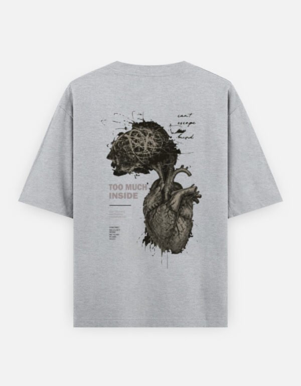 Oversized streetwear T-shirt featuring Too Much Inside Emotional Graphic Tee India typography on the front and artistic heart graphic print on the back, photographed in a scenic sunset outdoor location.